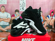 Angled view of the black and white Nike sneakers showing the side paneling, laces and contrasting sole.