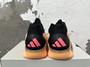 Rear view of black Adidas AE 1 basketball shoes with pink heel accents and peach-orange soles.
