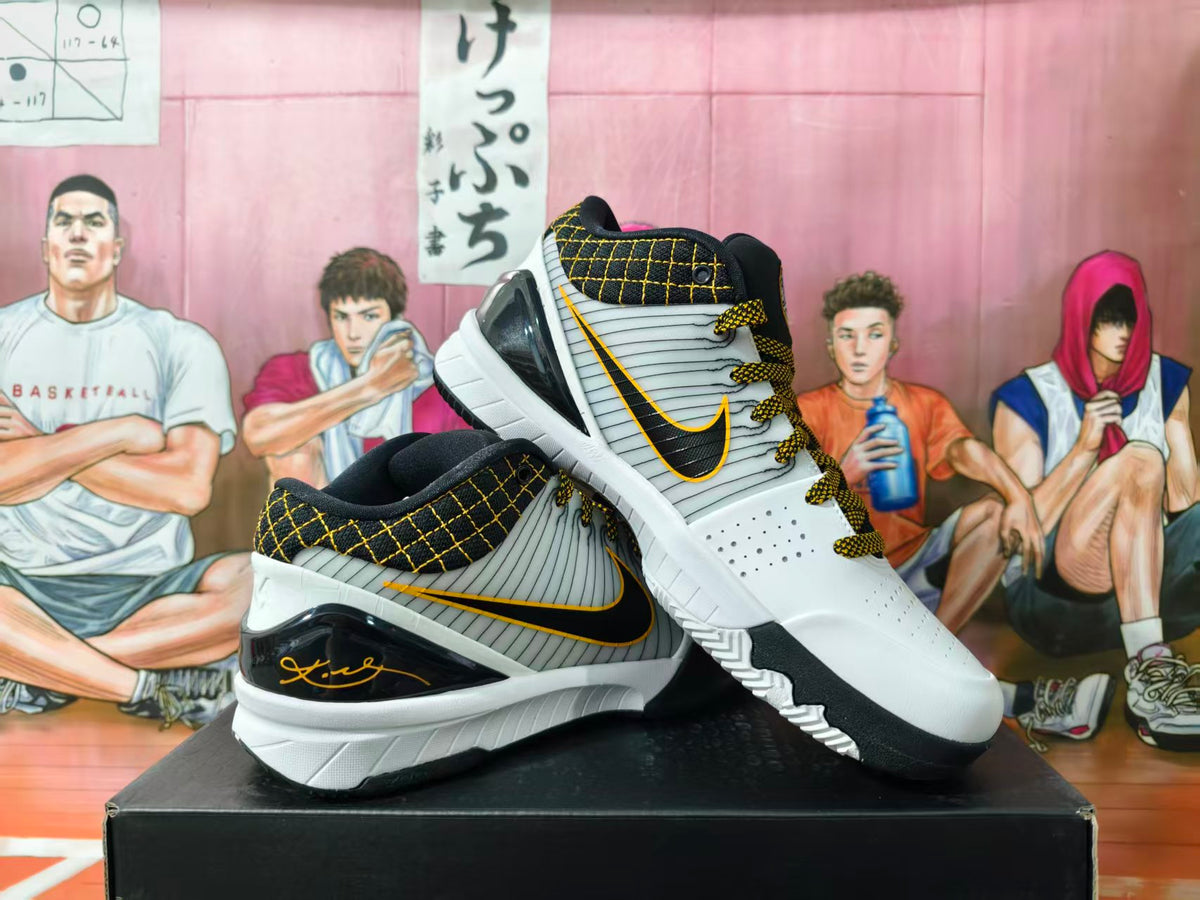 Pair of white, black, and gold Nike basketball shoes shown from the side and at an angle.
