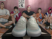 Front view of the white and blue sneakers showing the laces, rounded toes, and side detailing.