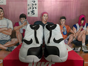 Front view of white and black Nike high-top sneakers with zip closures and black overlay panels.