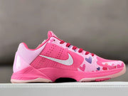 Side profile highlighting the pink upper, heart graphics, and white Swoosh