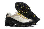 Nike Shox Ride 2 sneakers beside a view of the black outsole with yellow accents.