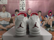 Rear view of white high-top sneakers with red Jumpman heel logos on a shoebox