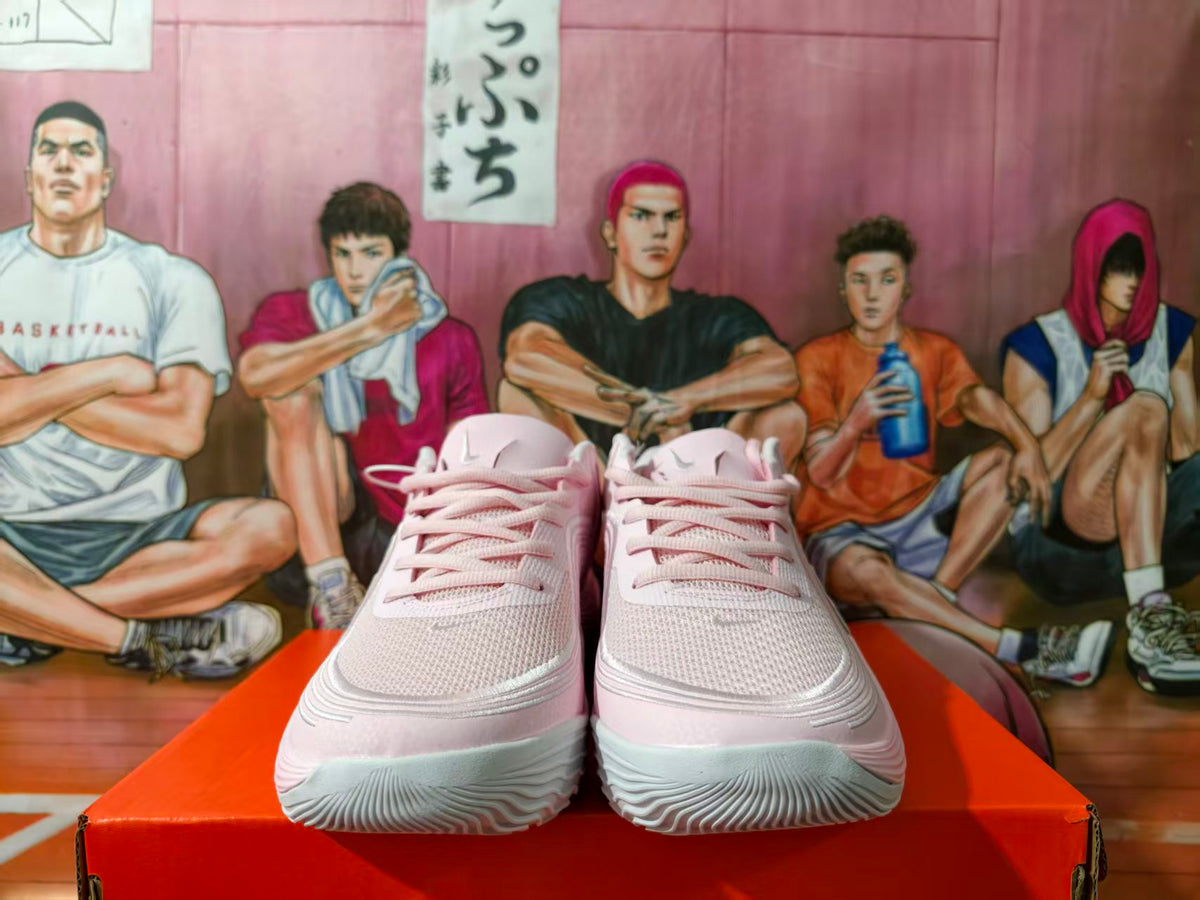 Front view of pink Nike basketball sneakers on an orange box