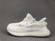 Side profile of the white sneaker showing the laces, knit-look upper, and translucent sole.