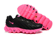 Black and pink sneakers shown from the side and underside