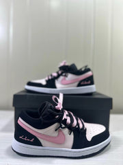 Pair of black, pink, and white low-top sneakers with ribbon lace details