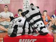 Angled view of black-and-white Nike high-top sneakers with AIR lettering and graphic side panels.