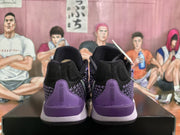 Rear view of black and purple Nike basketball sneakers showing the purple heel panels and layered soles.