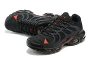 Angled top view of black Nike Air Max Terrascape Plus sneakers with red details and lace-up closure.