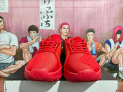 Front view of red basketball shoes with lace-up uppers and patterned soles