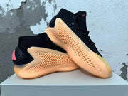 Pair of black Adidas AE 1 high-top shoes displayed at an angle, showing textured peach-orange side panels.