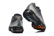 Rear and outsole views of grey Nike Air Max 95 TT sneakers with orange outsole accents