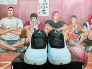 Front view of the pair showing blue-gray toe panels, patterned laces, and Jumpman tongue logos.