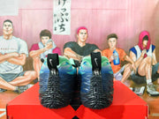 Rear view of blue and green Nike basketball shoes with black sculpted soles