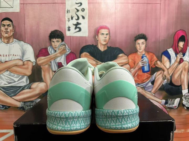 Rear view of mint, cream, and coral basketball shoes showing patterned heel details.