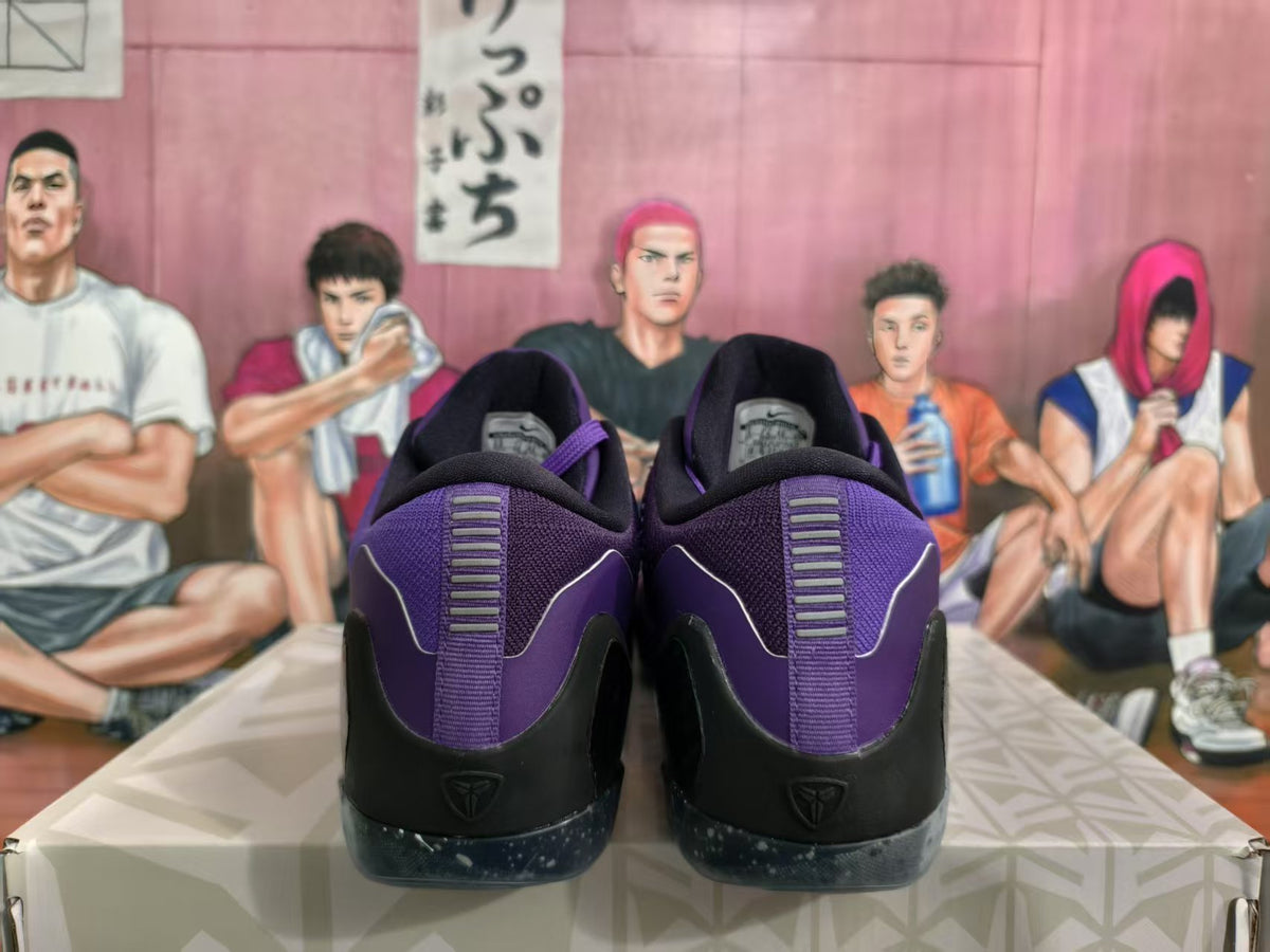 Rear view of purple Nike basketball sneakers with black heel panels and speckled soles.