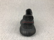 Rear view of a black sneaker showing the padded collar, heel pull tab, and red stitching.