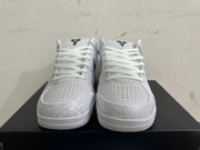 Front view of white Kobe basketball shoes showing perforated toe panels and black tongue logos