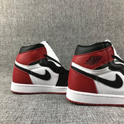 Close-up of the black Swoosh and red heel panel on Air Jordan 1 high-tops