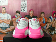 Front view of a pair of pink and white Jordan Luka 1 shoes.