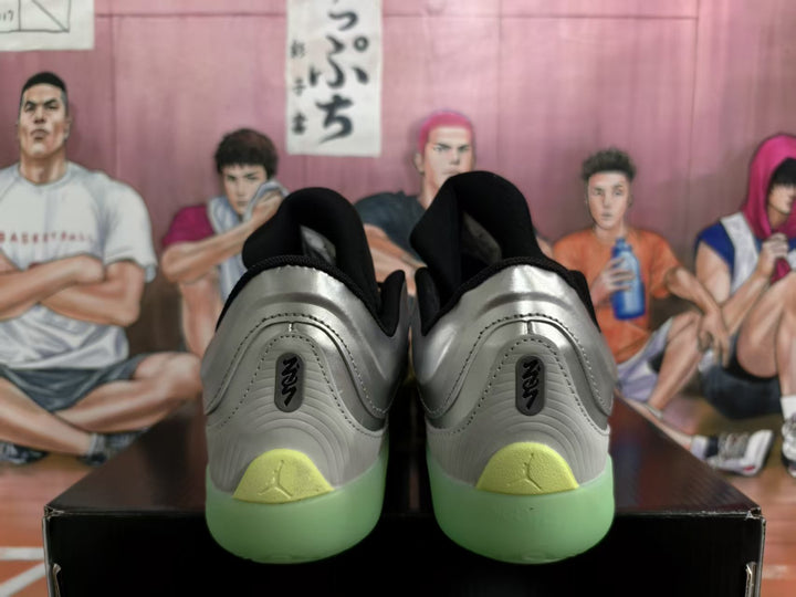 Rear view of silver and black Jordan basketball sneakers showing Jumpman heel branding and translucent pale green soles.