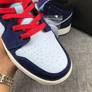Close-up of the white perforated toe box, purple overlays and red laces.