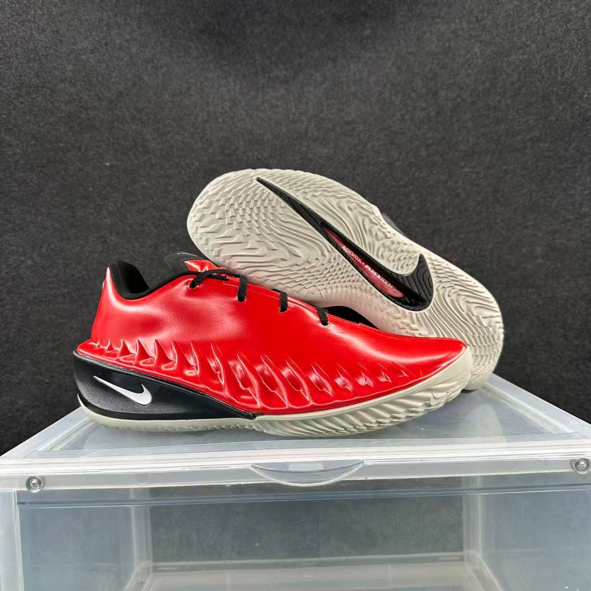 Red and black Nike GT basketball shoes shown from the side and outsole