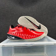 Red and black Nike GT basketball shoes shown from the side and outsole