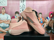 Angled view of pink Nike basketball shoes with black laces and dark outsoles