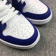 Detailed view of the perforated white toe box, blue overlay, and textured outsole edge