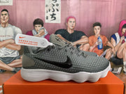 Side profile of a grey and black Nike KD basketball sneaker showing the black Swoosh, textured upper, heel panel, and sculpted white outsole.