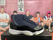 Side profile of a black and dark blue high-top sneaker with red Jumpman branding, glossy black panels, a white midsole, and translucent outsole.