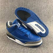 Blue Jordan sneakers shown from above with one outsole facing upward, displaying the tread and Jordan branding.