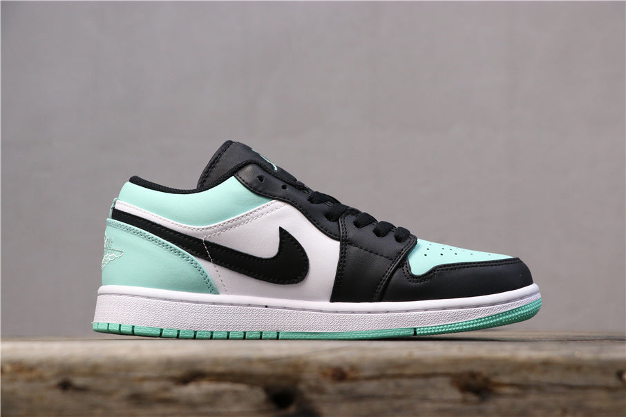 Side view of a low-top Air Jordan 1 sneaker with black, white, and mint-green panels.