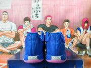 Rear view showing the heel badges and pink-tinted outsoles of the royal blue shoes.