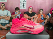 Side view of a pink Nike basketball shoe showing the Swoosh, layered panels, and sculpted outsole.