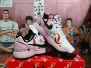 Angled view of the pair showing the black Swoosh, pink heel panels, red-orange graphics, and black rubber outsole.