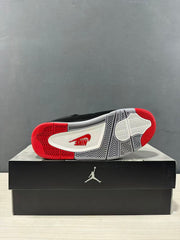 Bottom view of the sneaker showing a white, black, and red patterned rubber outsole.