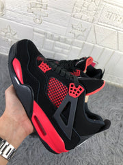 Angled side view showing the black upper, red midsole accents, and red side mesh.