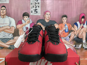 Front view of red and black Nike sneakers with black laces