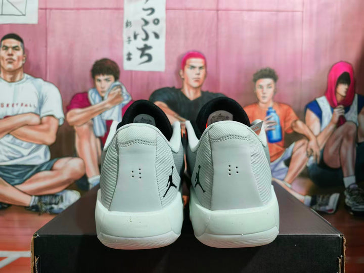Rear view of the black and gray sneakers showing Jordan heel logos, white midsoles, and a basketball-themed background.