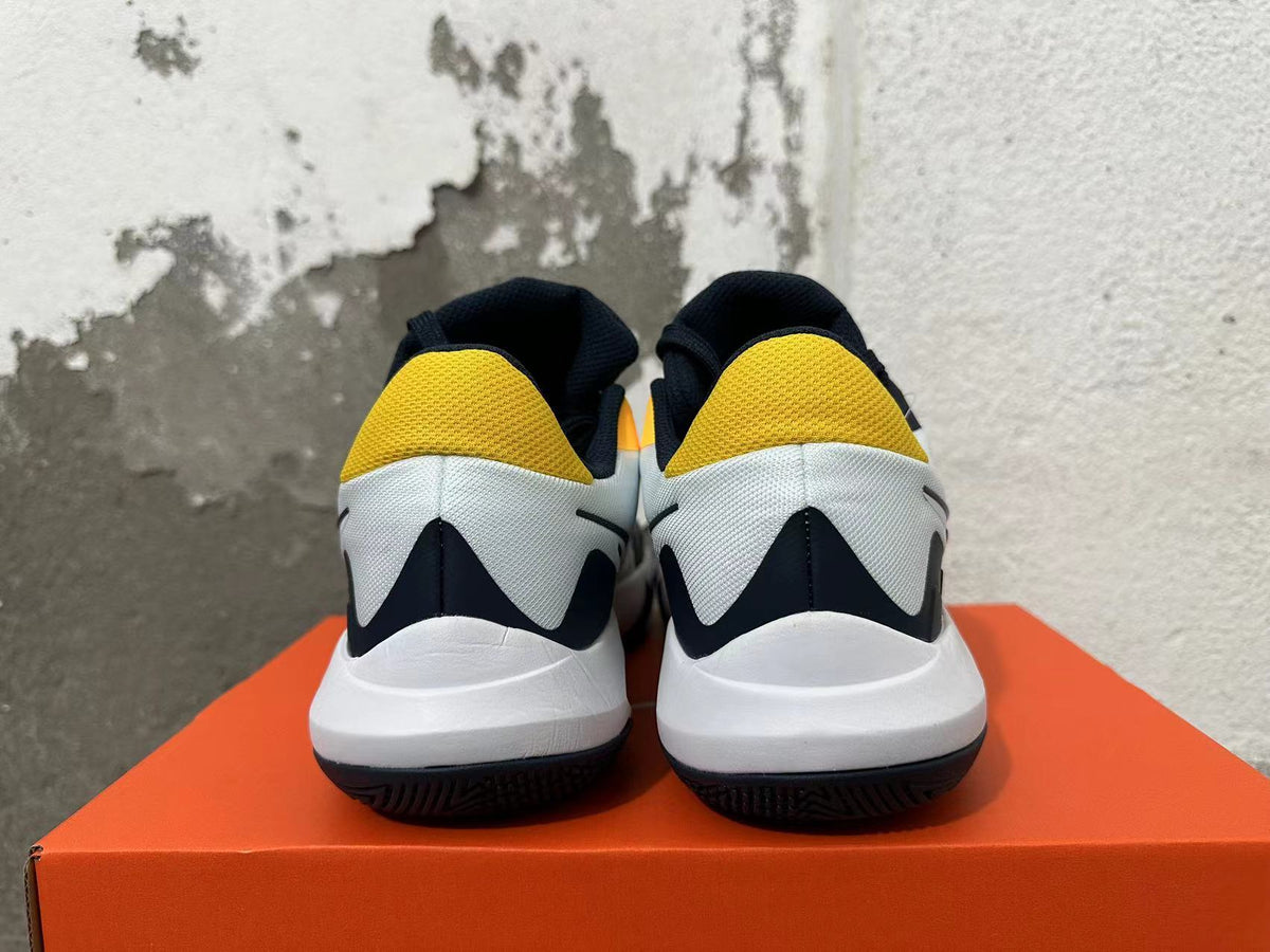 Rear view of white, navy and yellow Nike basketball shoes