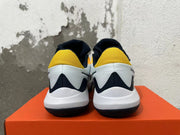 Rear view of white, navy and yellow Nike basketball shoes