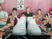 Front view of grey and white basketball shoes with patterned uppers