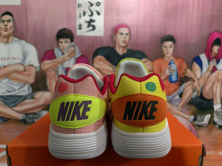 Rear view of mismatched yellow and pink Nike sneakers with contrasting heel panels and white textured outsoles.