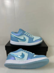 Angled view showing the sneaker upper, white laces, layered panels, white midsole, and translucent outsole.