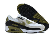 Pair of Nike Air Max 90 QS sneakers shown from the side with the patterned outsole visible.