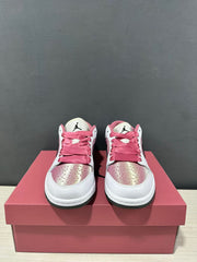 Front view of the pair showing pink laces, perforated toe boxes, and tongue branding.